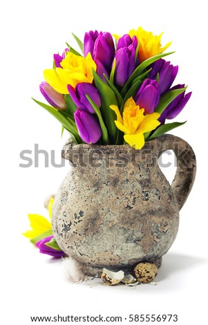 Spring flowers and easter eggs over white