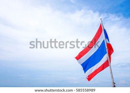 Thai flag of Thailand with blue sky background.