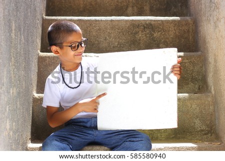 Indian child showing board