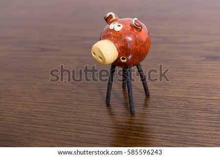 Clay pig on a table symbolizing wealth 