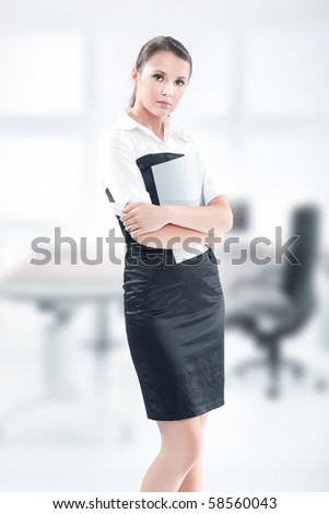 An attractive businesswoman holding files