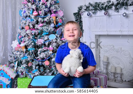 The boy next to Christmas tree