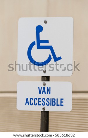 Handicap sign with van accessible at a parking lot