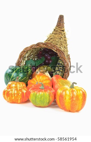 Still picture of Pumpkins, corn and grape in a basket Traditional symbols of Thanksgiving Day and Harvest.