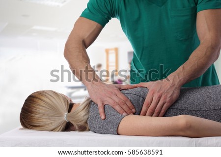 Woman having chiropractic back adjustment. Osteopathy, Alternative medicine, pain relief concept. Physiotherapy, sport injury rehabilitation Royalty-Free Stock Photo #585638591