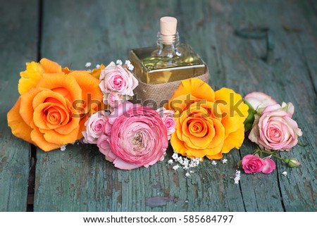 Still life with colorful roses and a gift on an old shabby wooden table for mothers day