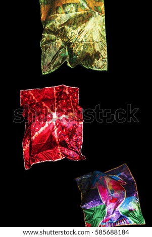 colorful Turkish Oriental beautiful scarves with pictures of natural silk on a black background