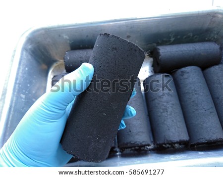 Close up of the coconut shell charcoal briquette.