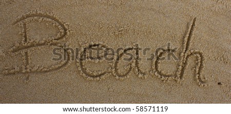 word "Beach" written in the sand on the beach