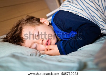 Infant baby boy kid sleeping in bed. Sweet dreams. Toddler taking a tap. Royalty-Free Stock Photo #585732023