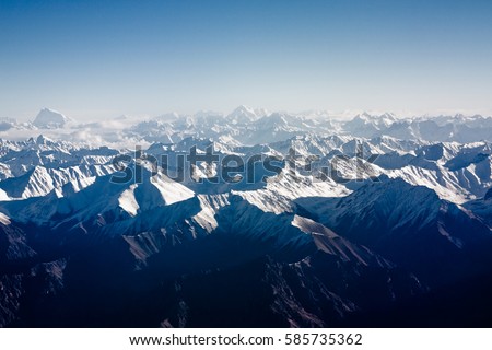 Himalaya mountains under clouds.View from the airplane ,ladakh,india Royalty-Free Stock Photo #585735362
