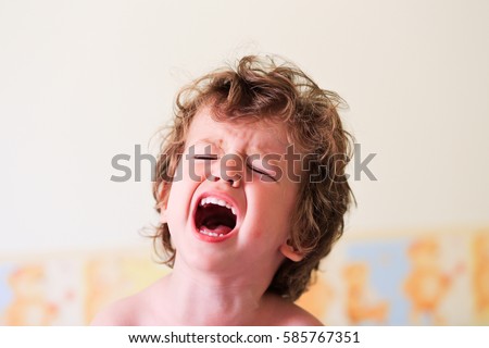 Portrait of a little toddler screaming. Upset baby boy kid crying. Shouting. Royalty-Free Stock Photo #585767351