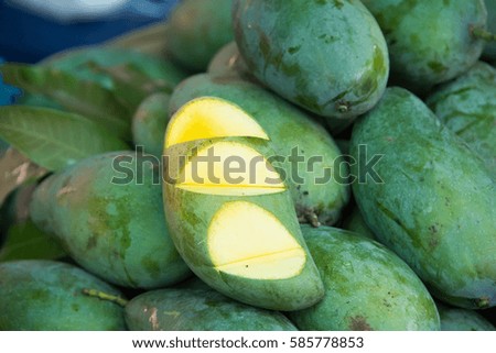 Mango for sale in a market, cut to show pulp