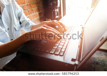 Woman office worker is typing keyboard with sunlight, silhouette style, close up