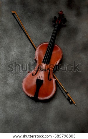 romantic violin and bow on gray background