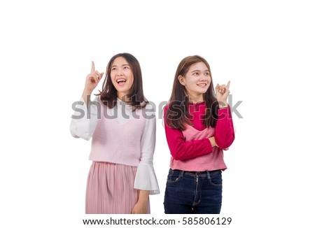 Two girls are pointing to other space in the blank space.