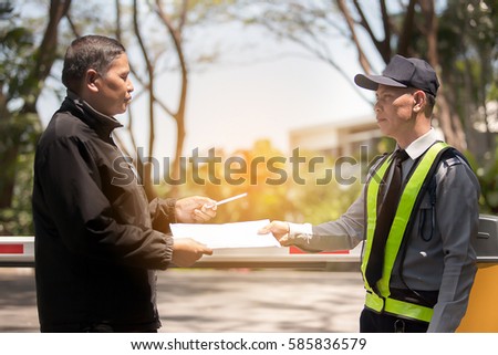 at Check-point security receiving parcel from delivery man 