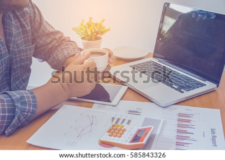 businessman holding cup of warm coffee on the background