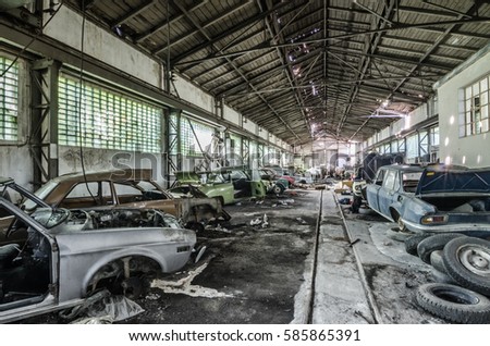 huge old abandoned hall with classic car Royalty-Free Stock Photo #585865391