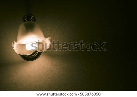Lamp night light in a dark background. Vintage effect style picture.