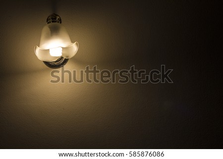 Lamp night light in a dark background. Vintage effect style picture.