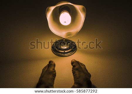 Lamp night light with leg in a dark background. Vintage effect style picture.
