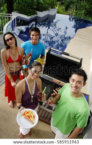 Couples at barbeque party, smiling at camera, portrait