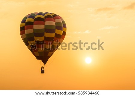 Balloons flying air over sunrise sky