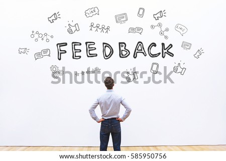 feedback concept, business man looking at the drawn sketch with icons  Royalty-Free Stock Photo #585950756