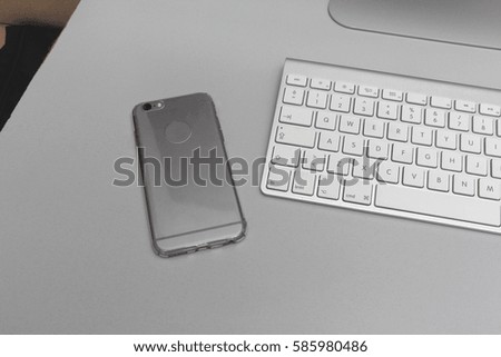 mobile phone and keyboard on desk