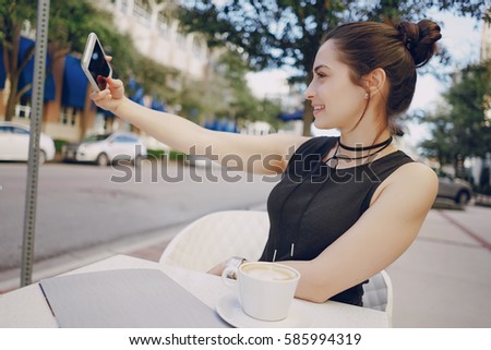 beautiful young girl is typing on phone