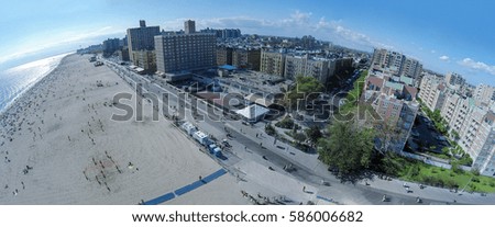Townscape with many people get rest on Brighton Beach at summer sunny day. Aerial panorama