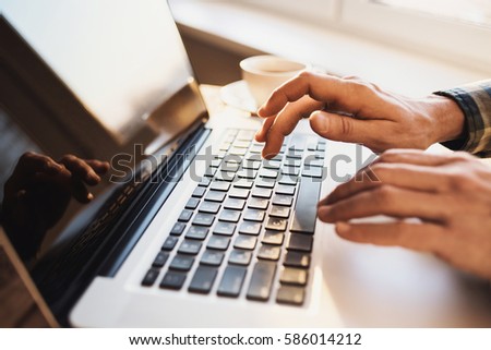 Businessman using laptop computer. Young man student working at home. Business, work from home, distance education, online learning, shopping online, studying concept. Journalist writing new article