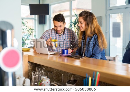 Couple enjoy in caffe restaurant.Colored photo
