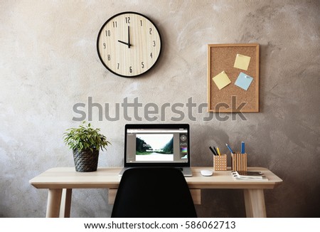 Modern workplace with laptop on table