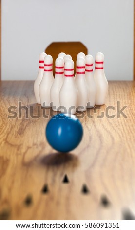 Bowling pins and bowling ball in miniature.