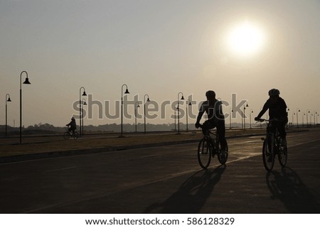 Silhouette of cyclist in motion on the background of  sunrise