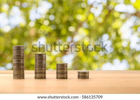 Business Finance and Money concept, Money coins stack growing graph with bokeh background, investment concept