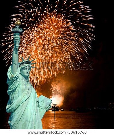 The Statue of Liberty and July 4th fireworks over Hudson River
