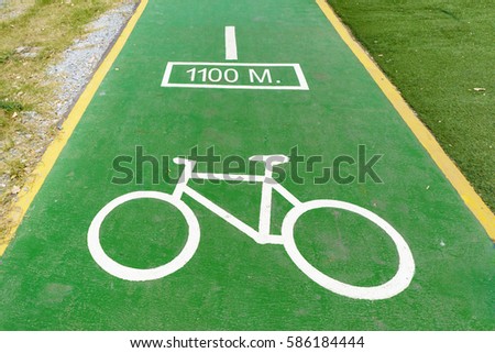 Green Bicycle lane with white bicycle sign in city. Bike lanes or cycle lanes are types of bikeways (cycleways) with lanes on the roadway for cyclists only.