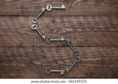 
old vintage keys on a wooden background  the form of letters of the entire alphabet