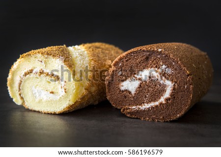 Vanilla and Chocolate Cake Rolls Isolated on a Black Background