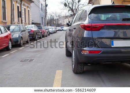 Picture of a crowded street with parking spots
