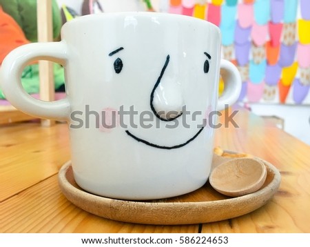 Art from a cup of coffee in cafe with wood table background, Cartoon cup