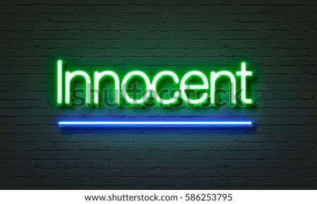 Innocent neon sign on brick wall background