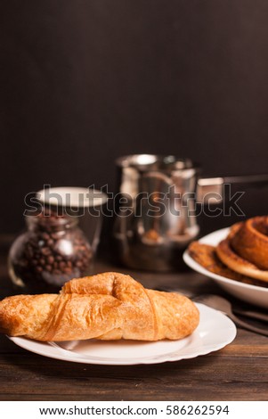 croissant bun coffee cup on the table