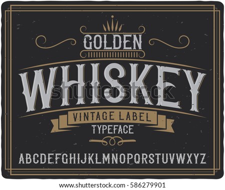 Vintage label typeface named "Golden Whiskey". Good handcrafted font for any label design. Royalty-Free Stock Photo #586279901