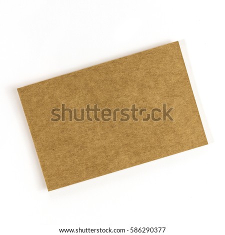 A photo of a kraft paper business card on a white background. A mockup or a minimalist banner with copy space