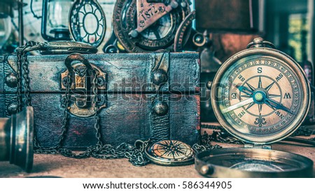 Antique compass and treasure box in vintage style picture.