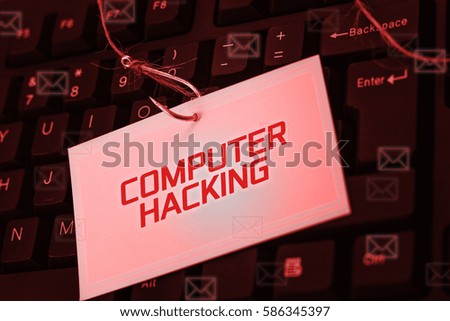Cyber and Technology concept, digital screen over the keyboard showing COMPUTER HACKING.